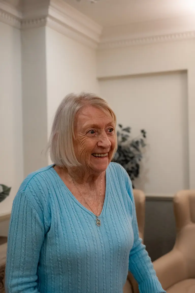 Two residents laughing together in the lounge at Aria Care Home