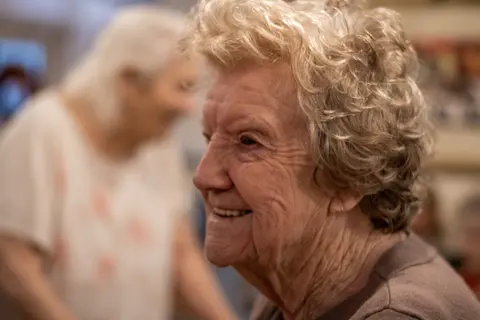Two residents dancing together, hands raised